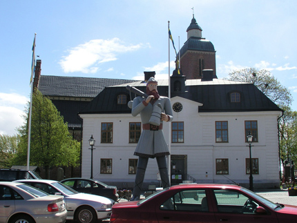 Mjölby old town hall, church, statue, parked cars
