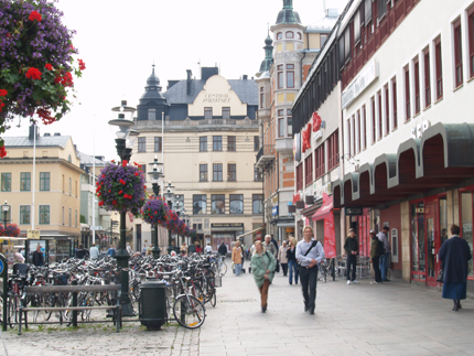 Main square in Linköping, Gallerian, people strolling, bicycles in bicycle racks, flowers in hanging flower pots
